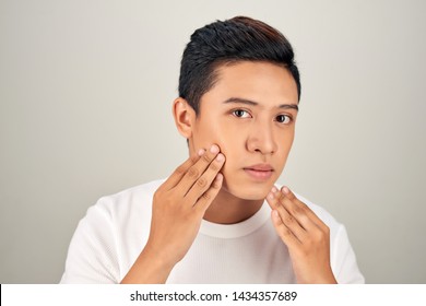 Portrait Of Shirtless Young Handsome Asian Man Checking His Face For Skin Care And Beauty Concepts