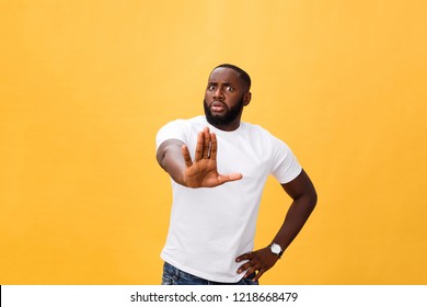 Portrait Shock And Annoyed Displeased Young Man Raising Hands Up To Say No Stop Right There Isolated Orange Background. Negative Human Emotion, Facial Expression, Sign, Symbol, Body Language