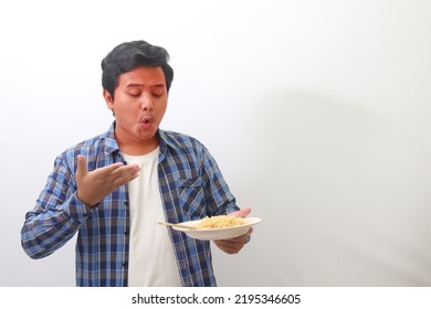 Portrait of shocked Asian man in plaid shirt eating spicy noodle and turning his face become red. Isolated image on white background - Shutterstock ID 2195346605
