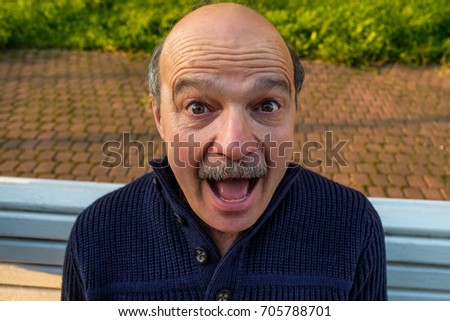 Portrait of shocked caucasian man. He is amazed with unexpected positive news