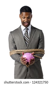 Portrait Of Shocked Hostage Businessman With A Piggy Bank On His Hand Isolated On A White Surface