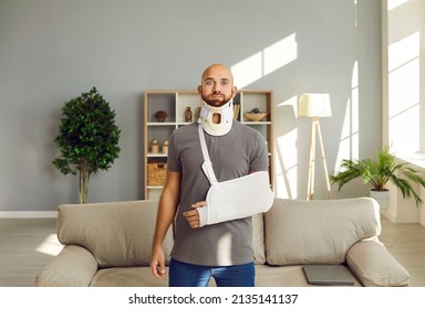 Portrait of shocked injured young man with bandage on arm and neck after accident or trauma. Stunned confused male with splint or sling on shoulder hand and back. Healthcare and rehabilitation.