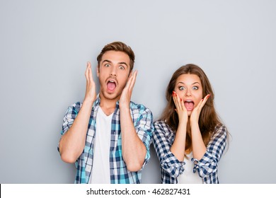 Portrait Of Shocked Man And Woman Screaming And Touching Face