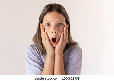 Portrait Of Shocked Preteen Girl Looking At Camera. Close-up Of Caucasian Child Wearing Blue T-shirt Expressing Surprise. Awe And Admiration Concept