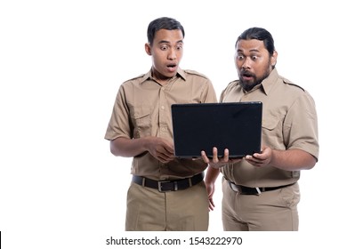 Portrait Of Shocked And Suprised Worker While Looking At Laptop Together