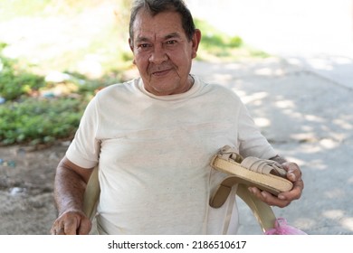 Portrait Of Shoemaker Repairing Shoes In The Street