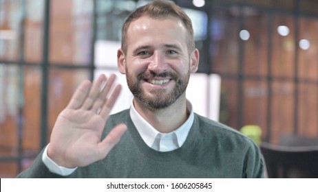 Portrait Shoot Of Handsome Man Waving At Camera