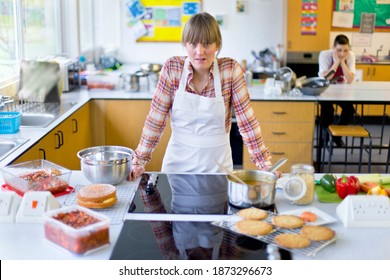 Portrait Shot Of A Frustrated Home Economics Teacher Cooking In A Kitchen Classroom.