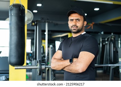 Portrait Shot Of Gym Trainer Or Coach Standing At Gym With Crossed Arms By Looking Camera - Concept Of Small Business Owner, Self Employed And Bodybuilder.