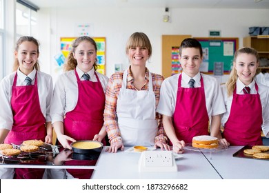 Portrait Shot A Home Economics Teacher And Her Students With Desserts In The Kitchen Classroom.