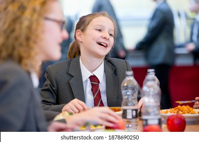 Portrait Shot Of A Middle School Student Eating Lunch In The School Cafeteria.