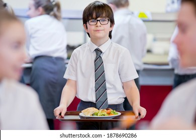 Portrait Shot Of A Middle School Student Carrying Lunch Tray In The School Cafeteria.