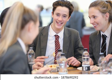 Portrait Shot Of Middle School Students Eating Lunch In The School Cafeteria.