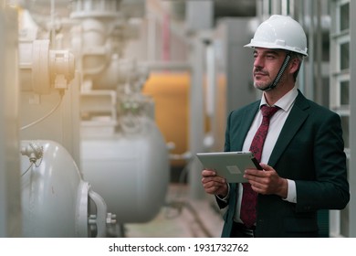 Portrait shot of senior engineer or management inspecting work in the boiler room in factory - Powered by Shutterstock