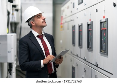 Portrait Shot Of Senior Engineer Or Management Inspecting Work In The Electrical Control Room In The Heavy Factory