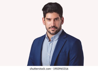 Portrait Shot Of Serious Faced Businessman Standing At Isolated White Background. Copy Space.