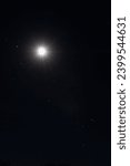 Portrait shot of shining full moon in nightsky with stars around