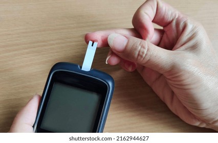 Portrait Showing Glucose Meter Reading Blood Sugar Level Of The Patient Woman, Concept Health Care.