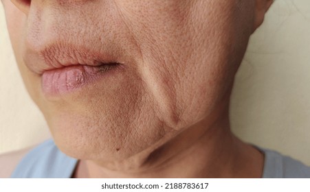 portrait showing the wrinkles skin, Flabby sagging and dry skin beside the mouth, blemishes and dark spots on the face, problem wrinkled and flabby skin of the Middle-aged woman, concept health care. - Shutterstock ID 2188783617