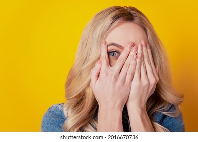 Portrait of shy adorable charming girl palms hide face eyes look camera on yellow background - Powered by Shutterstock