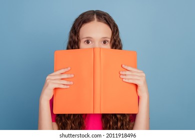 Portrait Of Shy Little Lady Hold Book Cover Half Face Look Camera On Blue Background