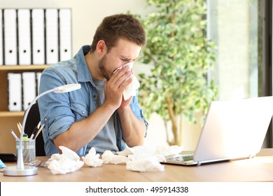 Portrait Of A Sick Entrepreneur Blowing In A Wipe At Office With A Lot Of Used Wipes On The Desk