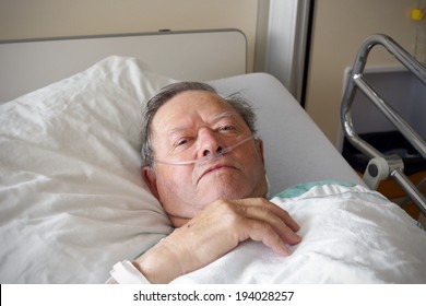 Portrait Of Sick Old Man In Hospital Bed