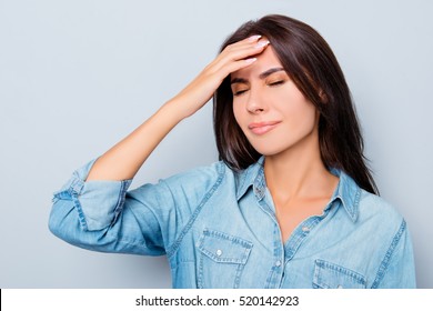 Portrait of sick young woman having strong headache.