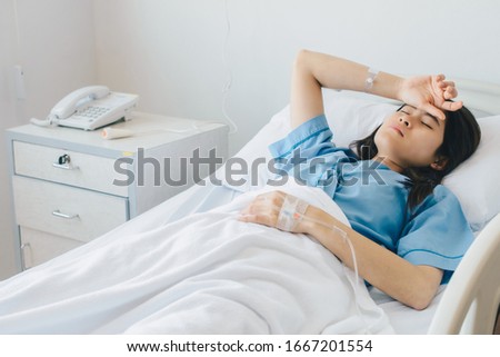 Portrait of sickness patient woman lying on hospital bed, resting for recovery. Conceptual of sickness woman feeling when admitted in the hospital.