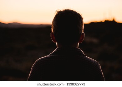 Portrait of a silhouette of a little boy in a sunset in the countryside. Child in nature - Powered by Shutterstock