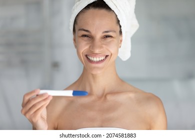 Portrait Of Sincere Joyful Young Latina Hispanic Woman Holding Plastic Stick Test In Hands, Feeling Excited Of Pregnancy Confirmation Results, Fertility Maternity, Childbirth Planning Concept.