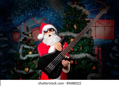 Portrait of a singing Santa Claus with electric guitar. Christmas. - Powered by Shutterstock