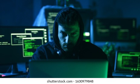 Portrait Of Sinister Computer Hacker Working With Codes Breaking Into Security System In The Company Office At Night.