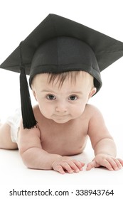 A Portrait of a sitting baby with a graduation cap