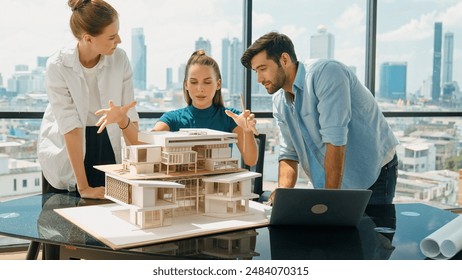 Portrait of skilled architect discussion with engineer team while using laptop. Group of businesspeople brainstorm and analysis building construction. Civil engineering, working together. Tracery - Powered by Shutterstock