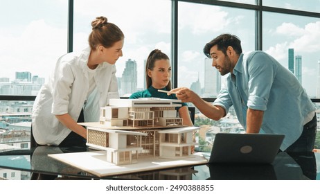 Portrait of skilled architect discussion with engineer team while using laptop. Group of businesspeople brainstorm and analysis building construction. Civil engineering, working together. Tracery - Powered by Shutterstock