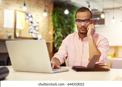 Portrait Of Skilled Software Developer In Casual Outfit Talking With Chief About New Features In Business Project On Cellphone Connected To 4G Internet,journalist In Spectacles Enjoying Free Time