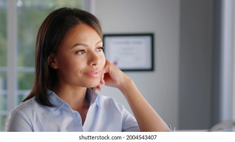 Portrait Of Skillful Afro American Female Executive Thinking Near Office Window. Close Up Portrait Of Pensive African Businesswoman Looking Through Window In Modern Office