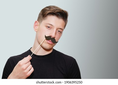 Portrait Of A Sly Look Man Wearing A Fake Paper Mustache