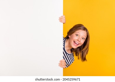 Portrait of small astonished lady open mouth unexpected promotion touch empty space wall isolated on yellow color background