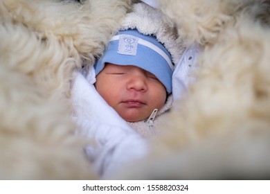 Portrait Of A Small Baby Sleeping Outside In Winter