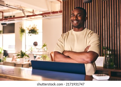 Portrait Of Small Business Owner In Shop Standing Behind Sales Desk Of Furniture Store