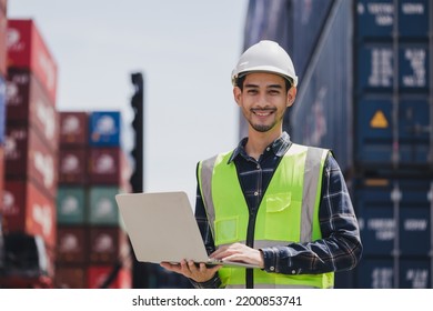 Portrait smart Asian engineer male wearing safety vest and hard helmet hand holding laptop computer standing in front of container box on site Cargo freight ship for import and export. Transport man - Shutterstock ID 2200853741