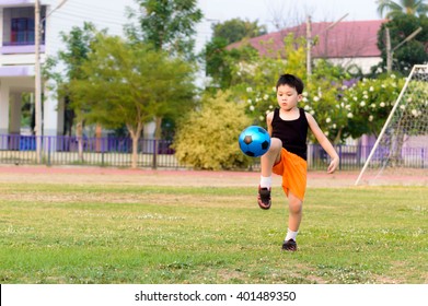 Portrait Smart Asian Soccer Player Kid Are Playing Ball At Soccer Stadium