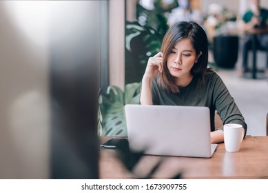 Portrait Of Smart Asian Woman Freelance Online Working With Laptop In Co-Working Space