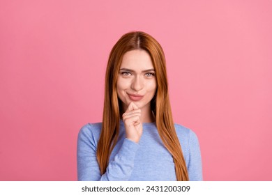 Portrait of smart confident girl with red foxy hairdo wear blue pullover think ideas hold finger on chin isolated on pink color background