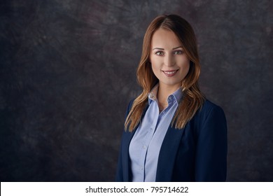 Portrait Of Smart Elegant Woman Standing Against Dark Background