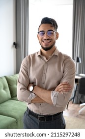 Portrait Of Smart Indian Business Man Looking At Camera Standing With Arms Crossed At Home Office. Headshot Of Confident Smiling Male Professional, Student, Ethnic Bearded Entrepreneur In Eyeglasses