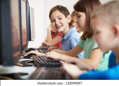 Portrait of smart lad looking at camera at computer lesson