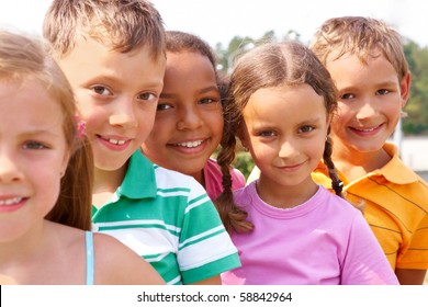 Portrait of smart preschoolers standing in row and looking at camera